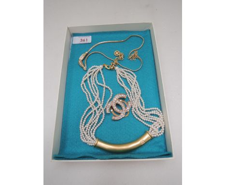 A 1980's simulated pearl necklace by Givenchy having central moulded panel, a similar gold plated necklace by Christian Dior 