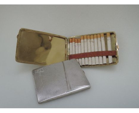 A silver cigarette case having Art Deco engine turned decoration and monogram to cartouche, London 1935, bearing Coronation m