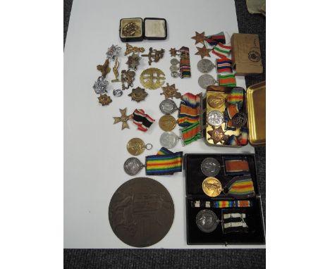 A selection of medals and badges to include Princess Mary's tin, three World War I medals to E J Trimmer RN, three World War 