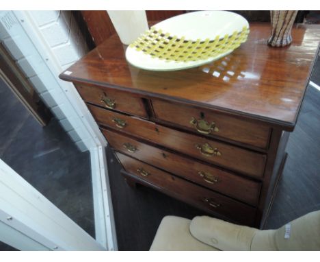 A 19th century mahogany chest of four long graduated cockbeaded drawers on bracket feet