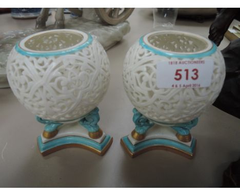 A pair of Royal China Works Worcester potpourri vases having reticulated tips and gilt heightened turquoise decoration number