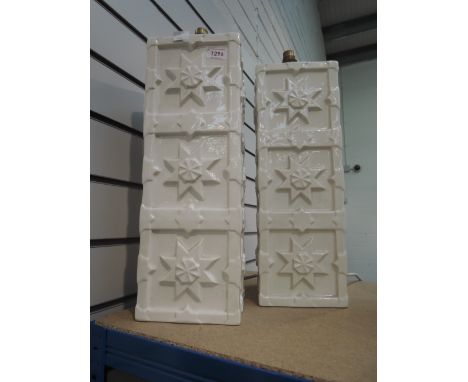 A pair of modern ceramic table lamps designed as white embosed towers