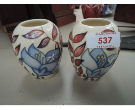A pair of modern Moorcroft small vases having Jacobs Ladder pattern on cream ground, stamped 2004