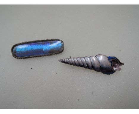 A vinatage white metal and butterfly wing brooch stamped 900 having shaped mount, and a white metal and enamel brooch modelle