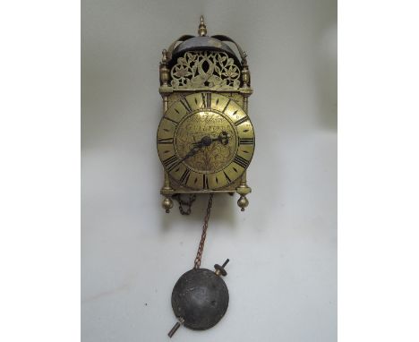 A vintage brass lantern clock of traditional 17th century style with pastel urn case, with engraved side frets, steel wedges 