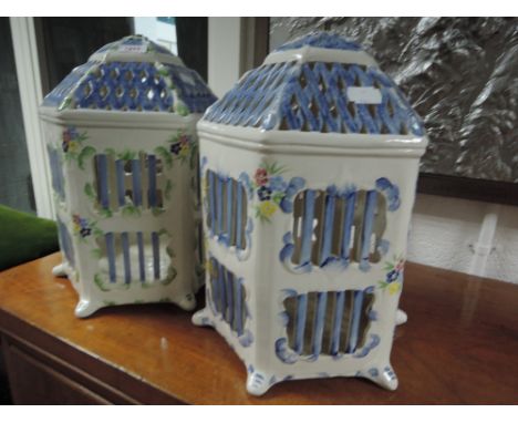 A pair of modern ceramic lamps designed as colourful bird cage/lanterns