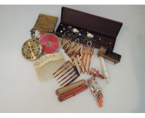 A selection of vintage ladies accessories including powder compacts, manicure set, cigarette holder, hair combs, hat pins, ne