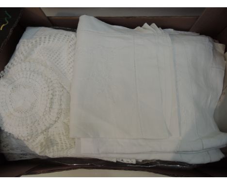 A selection of vintage table linen including crochet doillies, cut work and lace table cloths etc