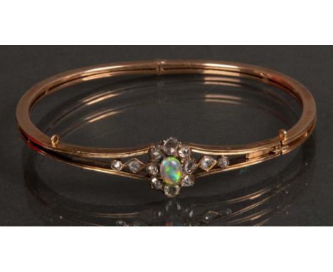 Armreif. 14 ct Gelbgold, ca. 16 g, besetzt mit Opal und Diamanten, ca. 0,50 ct.