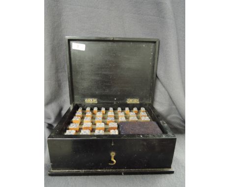 A vintage stamp set of numerals 1 to 31 with treen body and rubberised ends housed in treen box