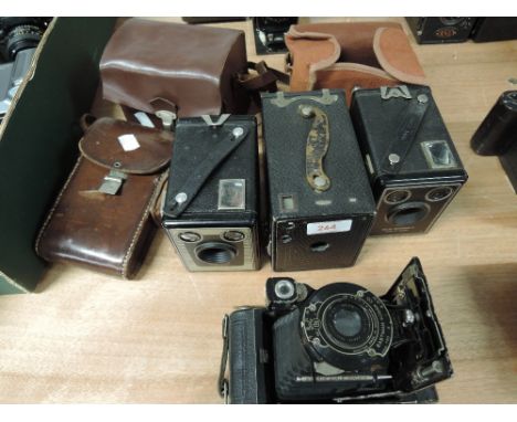 A selection of four Kodak cameras, including two Six-20 Brownie C's, an A120 folding camera, and a 120 box camera