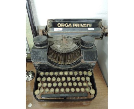 An antique typewriter with cast metal body the Orga Private