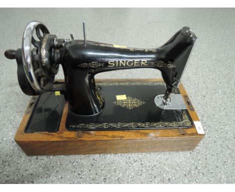 A vintage singer sewing machine with transfer print and crank handle serial number EC564646