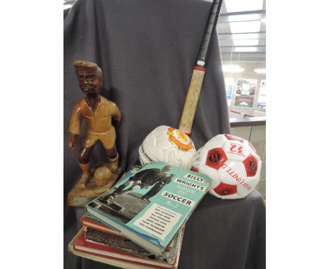 Two MUFC footballs bearing signatures, a selection of football annuals, a vintage hockey stick and a treen football trophy Vi