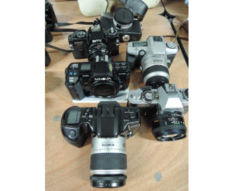 A Ricoh KR10, and five Minolta cameras including a 24 Rapid with instruction booklet, 7000 Maxum, Dinax 5, Dinax 500SI and an