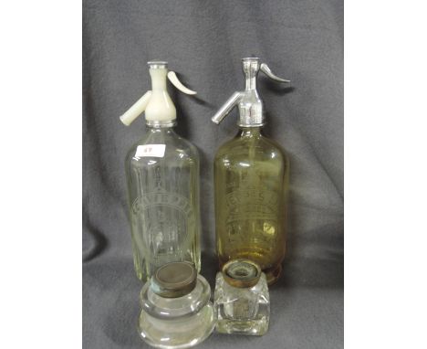 A selection of vintage ink wells and two accompanying soda siphons
