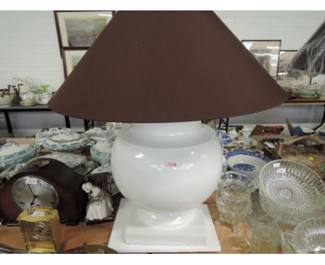 A large modern table lamp and shade