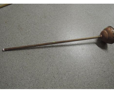 A vintage treen handle and copper washing device