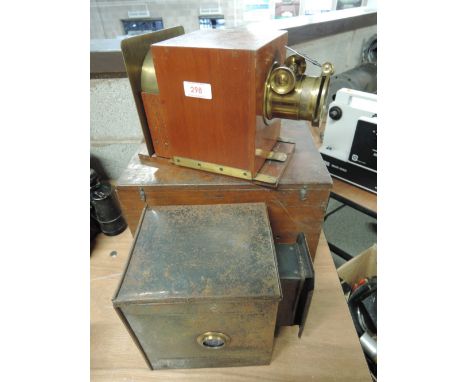 A boxed magic lantern lens in mahogany frame