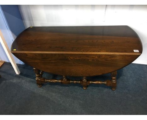 An Ercol oak drop flap table