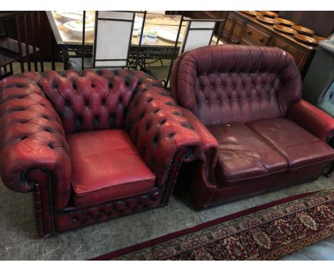 A Chesterfield red leather two seater settee and a club armchair