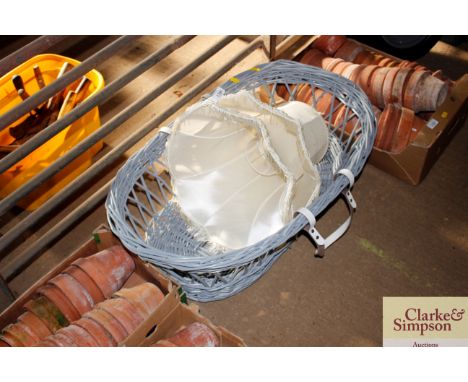 A Moses basket and two lamp shades 