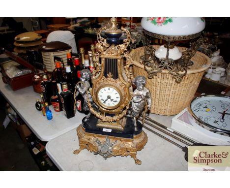 A French style two hole mantle clock decorated with cherubs
