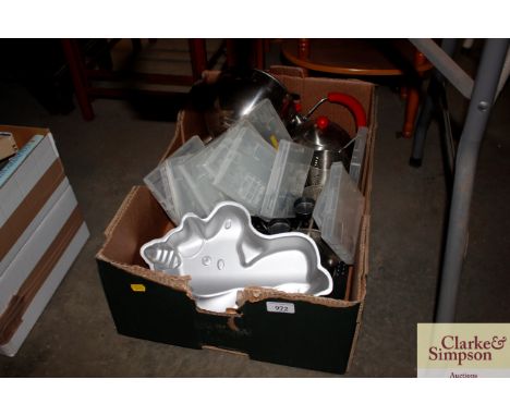 A box containing various tea light holders, jelly moulds etc.
