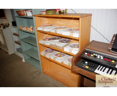 A light wood open fronted bookcase with adjustable shelves