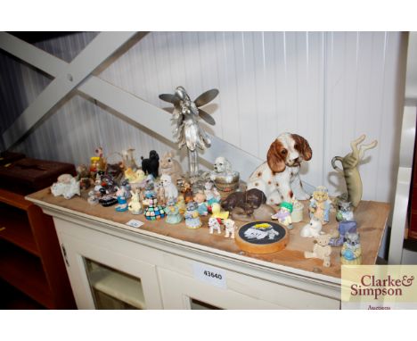 A collection of various ornaments to include Poole Pottery, model of a recumbent dog etc.