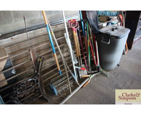 A quantity of long handled tools to include wooden rake, lawn spike, spades, forks and a landing net etc. 