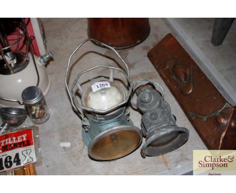 A vintage battery operated lantern torch and a vintage cycle lamp 