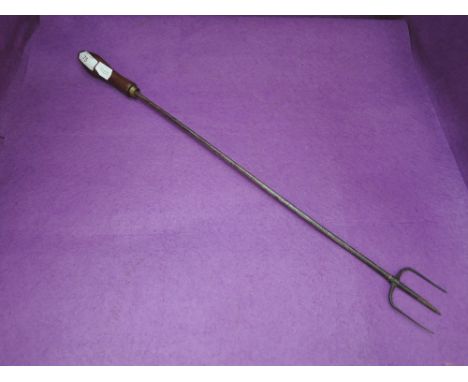 A vintage toasting fork with wood handle