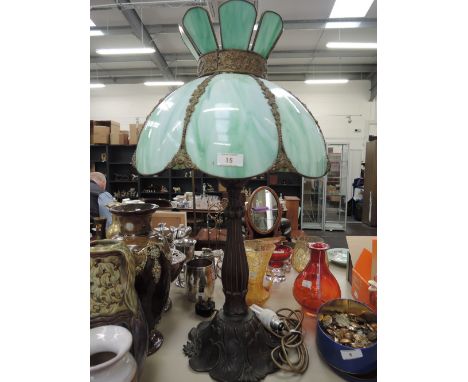 A modern Tiffany style table lamp having green shell glass shade on stem foliate base