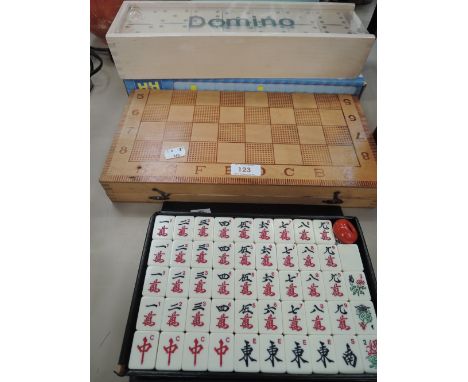 A selection of vintage board games including dominoes and Mah Jongappears to be complete