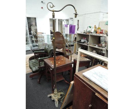An early 20th Century brass standard lamp having shaped trefoil base