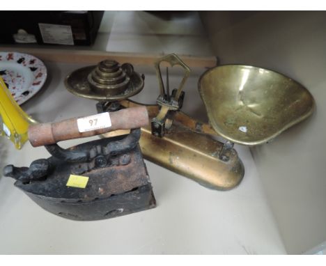 A set of vintage kitchen scales by JJGalowel and stove iron