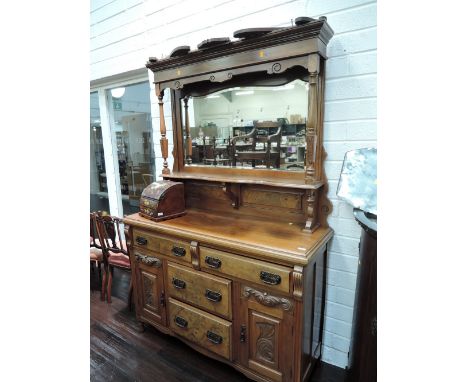 A late Victorian walnut and mahogany full height sideboard having raised pillar mirror back with Swan neck and shelf, over tw