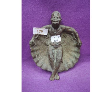 A vintage brass trinket dish or ashtray with African man reclined in shell