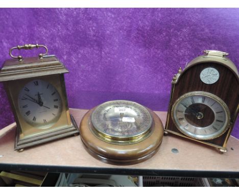 A selection of vintage mantle clocks and barometer