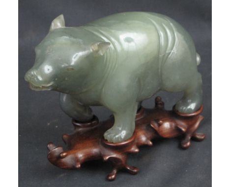 CHINESE CARVED JADE STUDY OF A STANDING, PROWLING BEAR with open mouth, detailed ears and clawed feet.  20cm long approx. on 