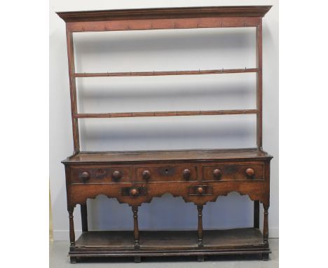 LATE 18TH CENTURY SOUTH WALES OAK DRESSER, having associated two shelf open rack with iron hooks under a moulded cornice, the