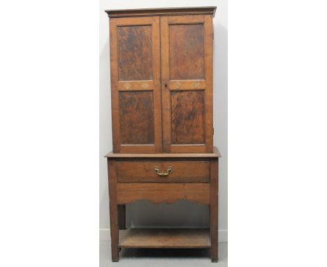 SMALL 18TH CENTURY OAK CUPBOARD ON STAND having two blind paneled doors revealing an interior fitted with shelves and drawer,