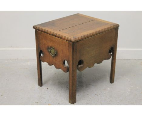 18TH CENTURY OAK COMMODE STOOL, having hinged framed top revealing cut out interior, shaped and scrolled frieze aprons to thr