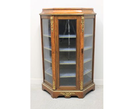 LATE VICTORIAN WALNUT AND BURR WALNUT GILT METAL MOUNTED SINGLE DOOR CANTED DISPLAY CABINET, having four shelves to the lined