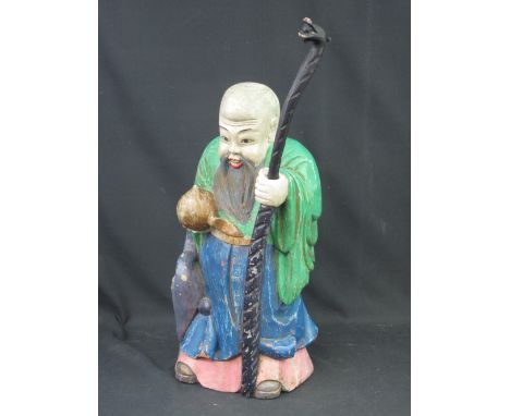 CARVED WOODEN, POLYCHROME DECORATED FIGURE OF A BEARDED STANDING IMMORTAL with long stick and gourd.  62cm high overall. COND