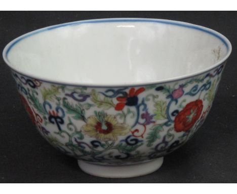 CHINESE PORCELAIN DOUCAI STYLE SMALL BOWL overall decorated externally with coloured, enamelled scroll work and flower heads 