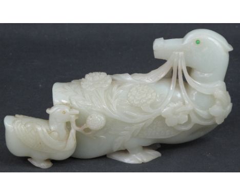 CHINESE CARVED PALE GREEN JADE STUDY OF A MANDARIN DUCK LOOKING BACKWARDS, with duckling, and overall decorated with flowers.