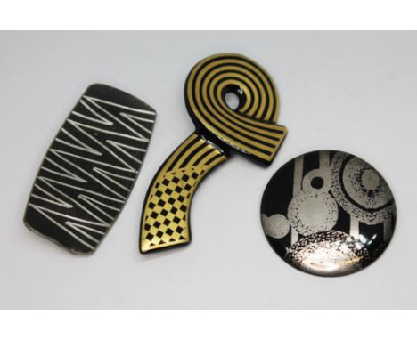 Three modernist brooches comprising a Danish pewter brooch no. 907 by Georg Jensen, a Rosenthal brooch and an Austrian brooch