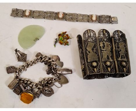 A antique silver bracelet with various charms, some marked silver, a German silver bracelet with filigree and cameos, a Germa